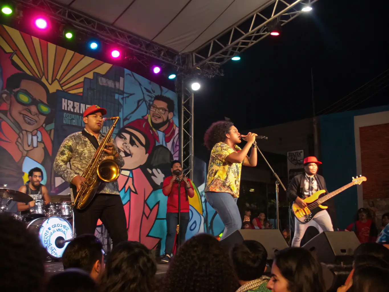 A vibrant image of a local band performing live at a community event supported by LE SON DU BOZ, showcasing the energy and talent within the community.